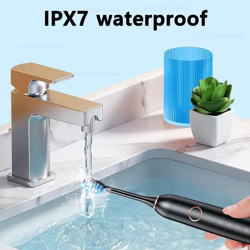 IPX7 waterproof electric toothbrush rinsed under a tap